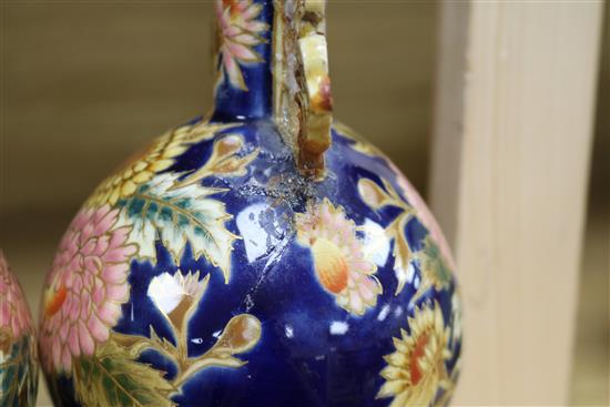 A pair of Zsolnay Pecs reticulated vases, floral-decorated on a blue ground and heightened in gilt height 20cm (a.f.)